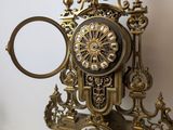 a clock that is sitting on top of a clear shelf
