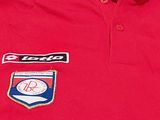 red polo shirt with a patch on the chest and a logo on the chest