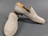 pair of men ' s white sued slippers on grey background
