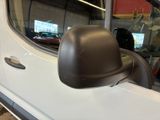 a side view mirror of a white truck in a garage