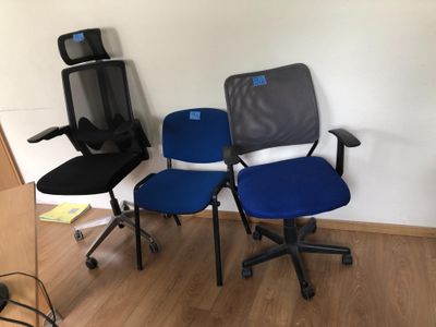 three office chairs in the corner of a room