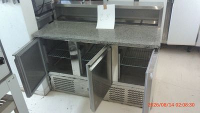 an image of a kitchen with a refrigerator and a counter top