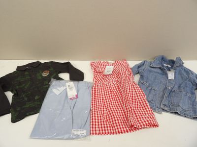 three pairs of children ' s clothes are lined up on a table