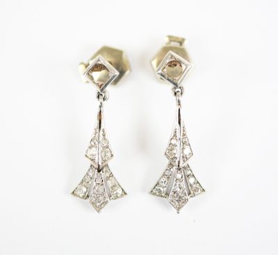 a pair of diamond earrings on a white background