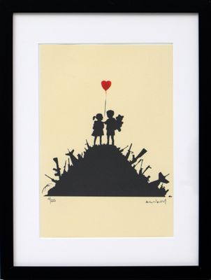 a black and white picture of a boy and girl holding a red balloon