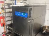 a machine that is sitting on a cart in a kitchen