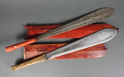 Deux couteaux et un étui à couteau sont posés sur une table