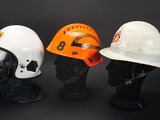 three different types of hard hats on display on a black background