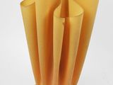 an orange lamp with a white base on a white surface