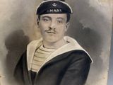an old photo of a man in a sailor ' s outfit with a hat on his head