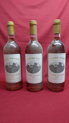 three bottles of wine are lined up on a red background