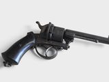 gun on a white surface with a white background