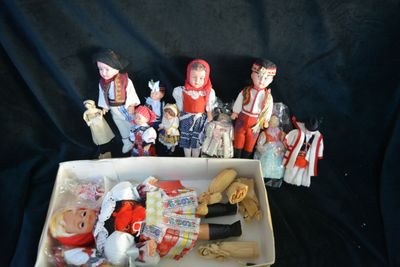 a box full of dolls that are sitting on a table