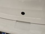 a close up of a white sink with a black faucet on it