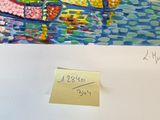 a picture of a piece of art with a note attached to it
