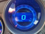 a close up of a car dashboard with a digital clock