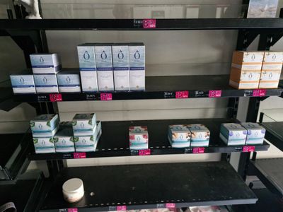 many boxes of toothpaste on the shelves in the store