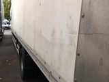 two trucks that are parked next to each other on the street