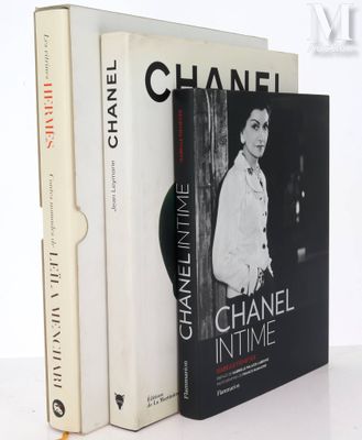 two books sitting on top of a white table next to each other