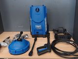 a blue pressurer sitting on top of a wooden table next to a hose