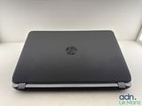 the hp laptop is sitting on a table with its lid open