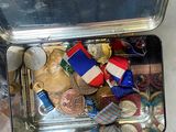 someone is holding a suitcase full of assorted items on a table