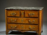 an antique chest of drawers with marble top and brass handles