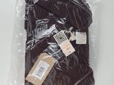 a close up of a bag of brown clothing on a white surface