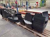 many tvs sitting on a pallet in a warehouse