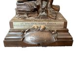 bronze statue of a man with a book and a dog