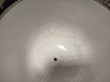 a close up of a white bowl on a table