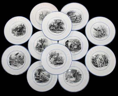 nine plates with black and white images of animals on them