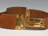brown leather belt with brass buckles on a white surface
