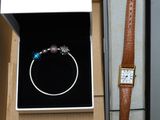 a box with a watch and a bracelet inside of it
