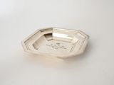 an antique silver plate on a white table with a white background