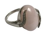 a close up of a ring with a pink stone on it
