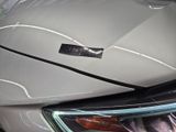 a close up of a car ' s headlight with a sticker on it