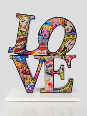 a close up of a sculpture of the word love on a white surface
