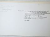 an open book with a poem on it on a table