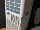 a white air conditioner sitting on a wooden table