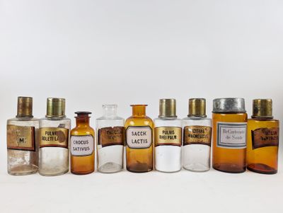 bottles of various sizes and shapes are lined up on a white surface