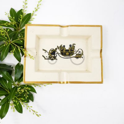 a plate with a picture of a horse and carriage on it