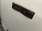 a close up of a sticker on the side of a white car