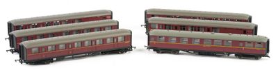 two red and white train cars sitting next to each other on a white surface