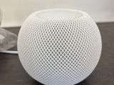 an apple homepod is sitting on a table next to a pair of shoes