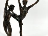 bronze statue of a couple of dancers on a white background