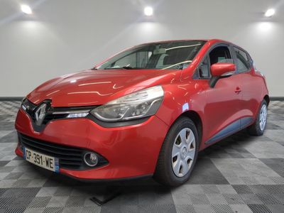 a red car is parked in a room with a checkered floor