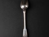 a spoon that is sitting on a black surface