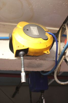 a yellow machine that is connected to a blue hose
