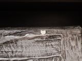 a close up of a piece of wood with a piece of paper sticking out of it